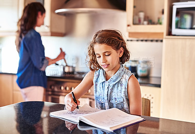 Buy stock photo Cropped shot of a young girl writing in a book while her mom cooks in the background
