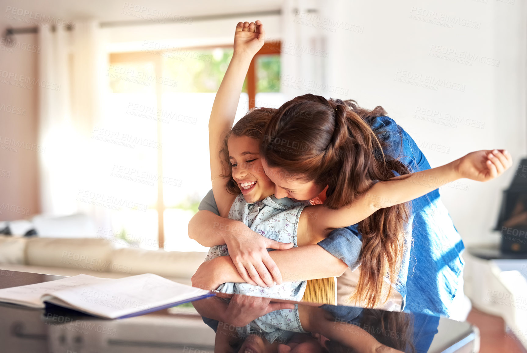 Buy stock photo Learning, hug or mother and daughter with homework in kitchen celebration, success and bonding at home. Education, books and excited mom embrace proud girl in house with school, project and support
