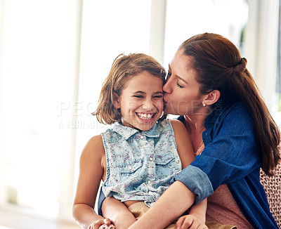 Buy stock photo Cropped shot of a mother kissing her young daughter