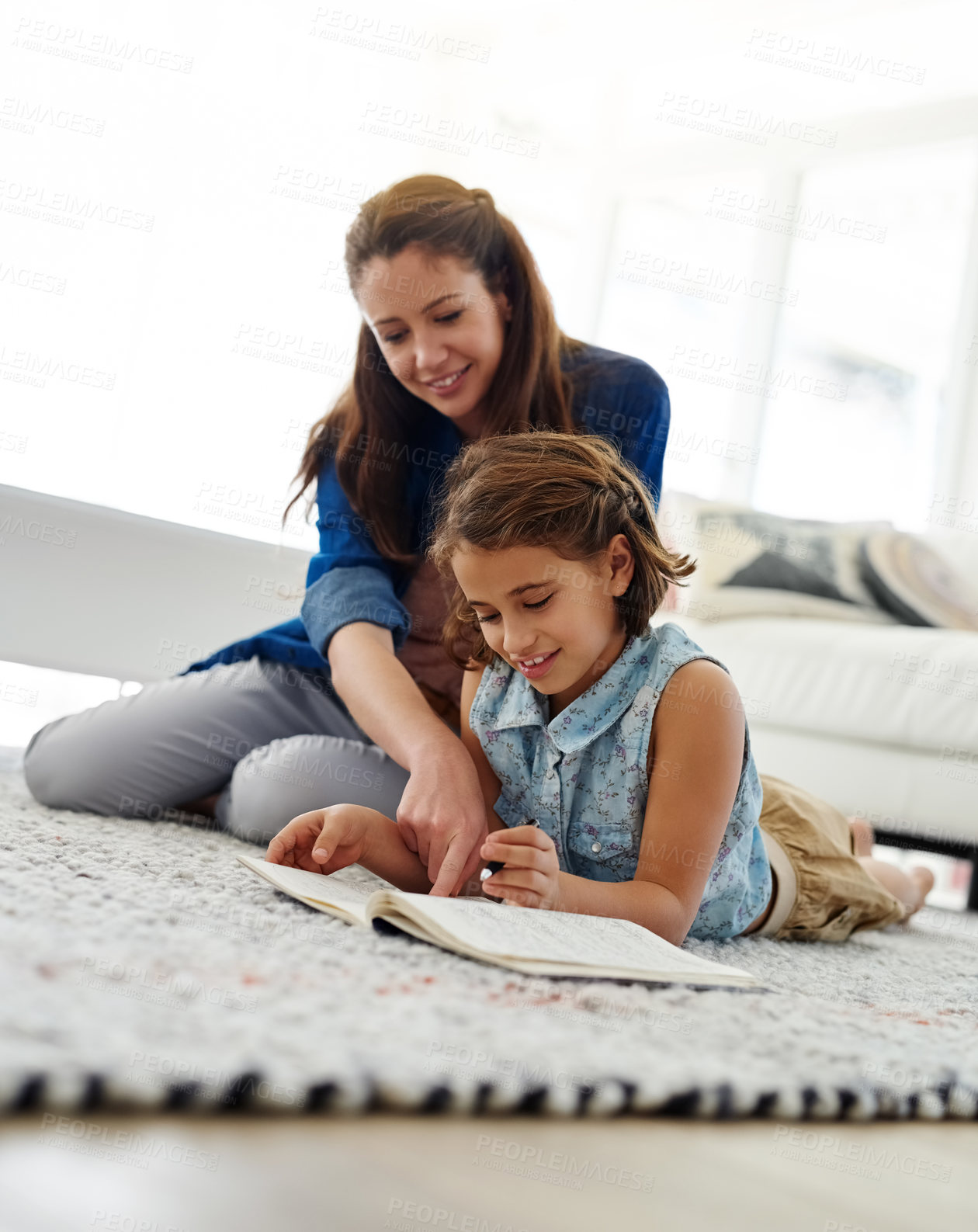 Buy stock photo Mother, girl and help with book on floor for learning, home school and writing for essay or english literature assignment. Mom, daughter and together on mat in living room for education and knowledge