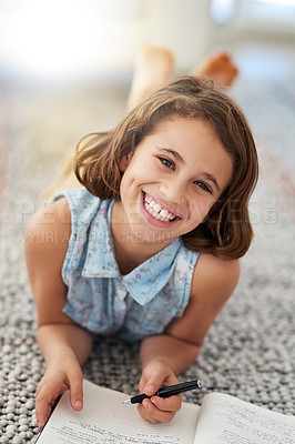 Buy stock photo Portrait of a young girl writing in a book at home