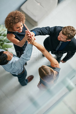 Buy stock photo High angle shot of a group of  businesspeople high fiving together in a modern office