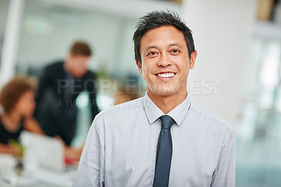 Buy stock photo Portrait of a smiling young businessman standing in a modern office