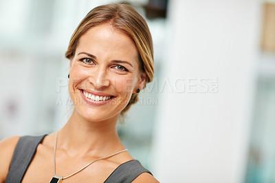 Buy stock photo Portrait of a smiling young businesswoman standing in a modern office
