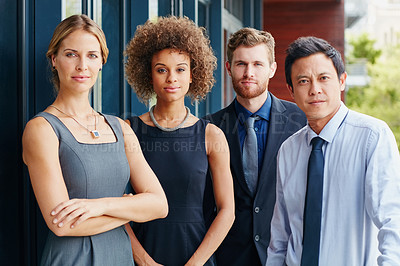 Buy stock photo Portrait of a group of focused young professionals standing together outside