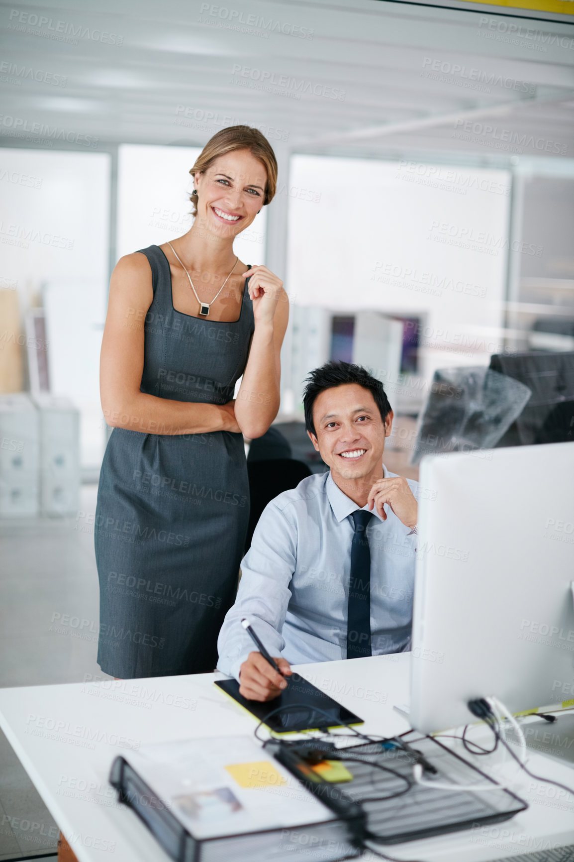 Buy stock photo Shot of two colleagues working together on a computer