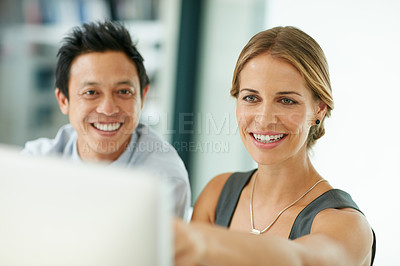 Buy stock photo Shot of two colleagues working together on a computer