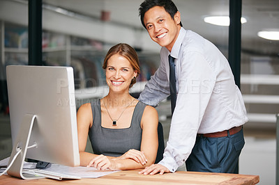 Buy stock photo Shot of two colleagues working together on a computer