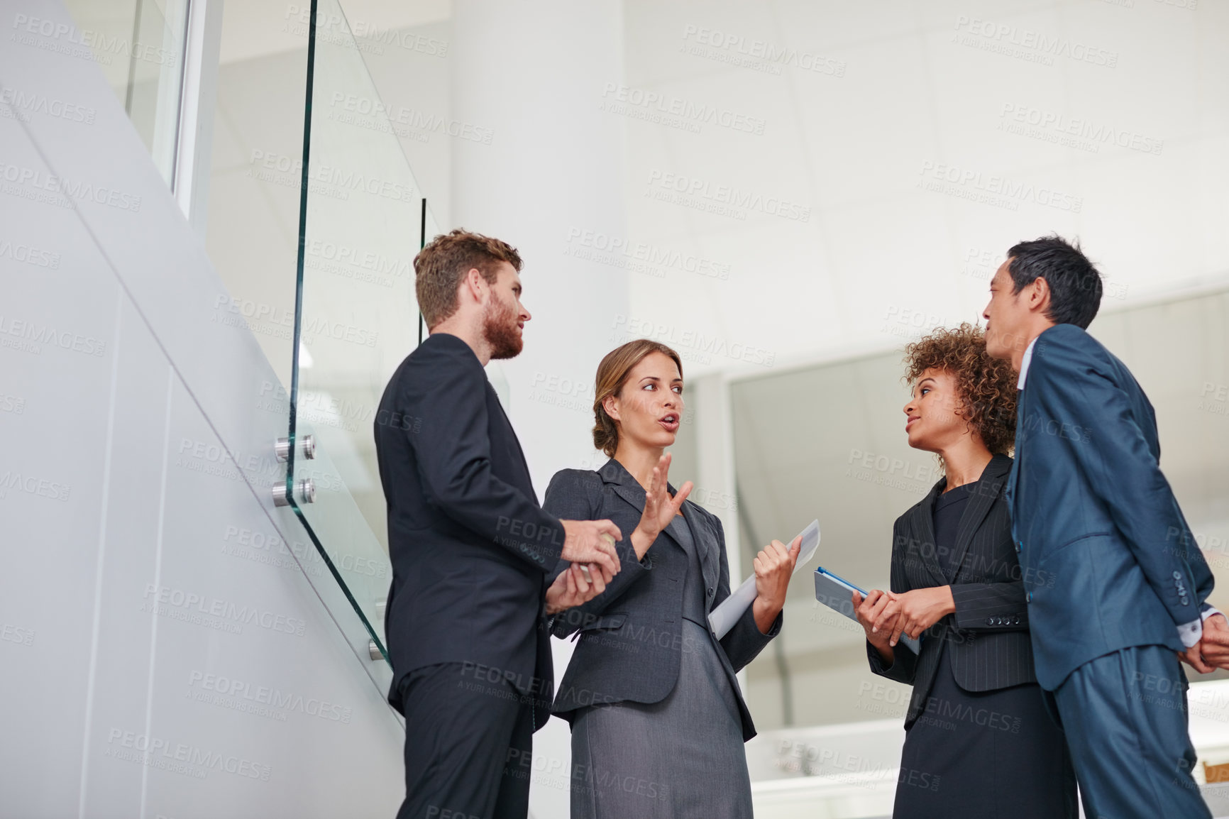 Buy stock photo Cropped shot of businesspeople having a discussion in a modern office