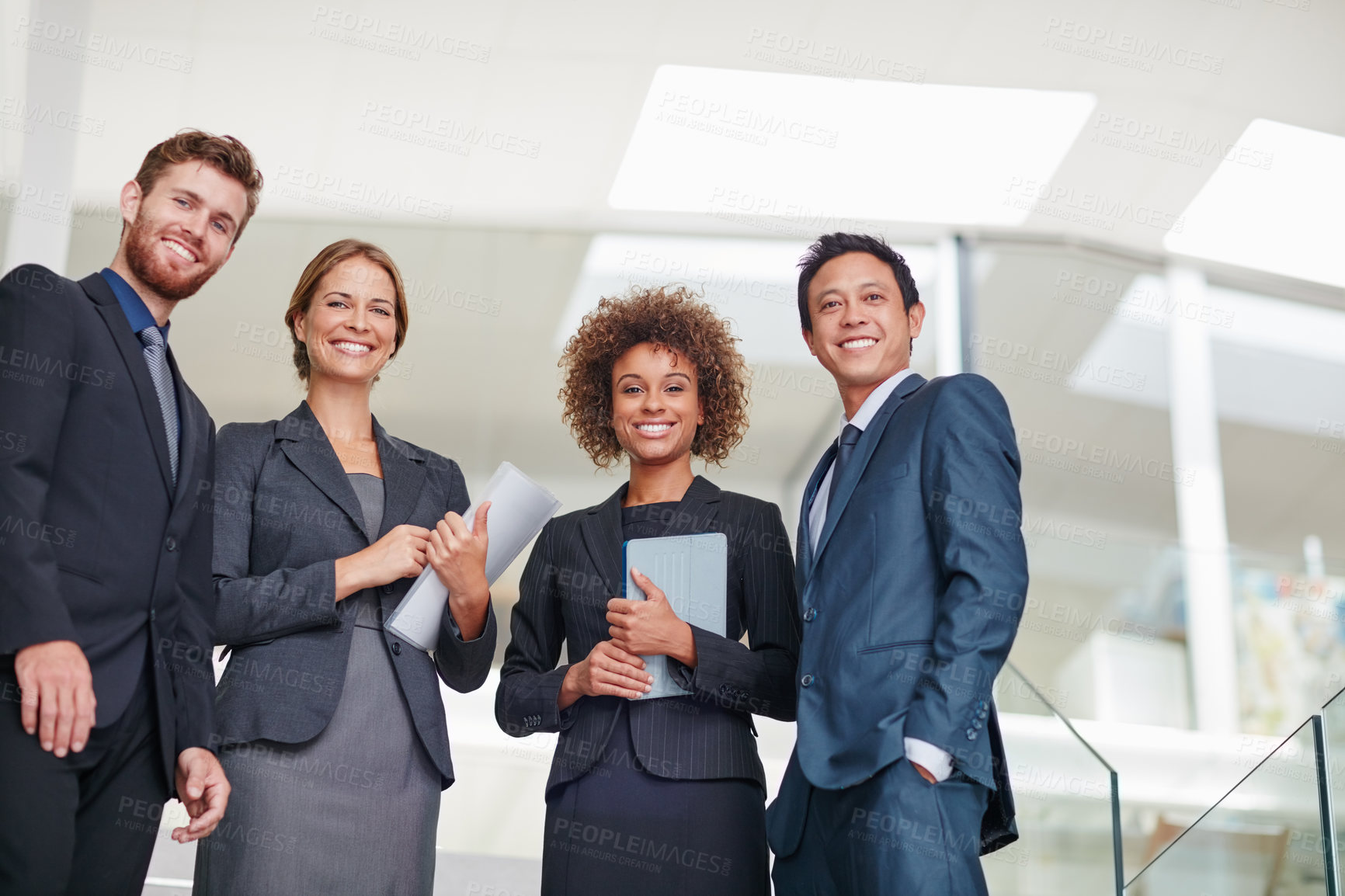 Buy stock photo Portrait of a group of businesspeople standing together in a modern office