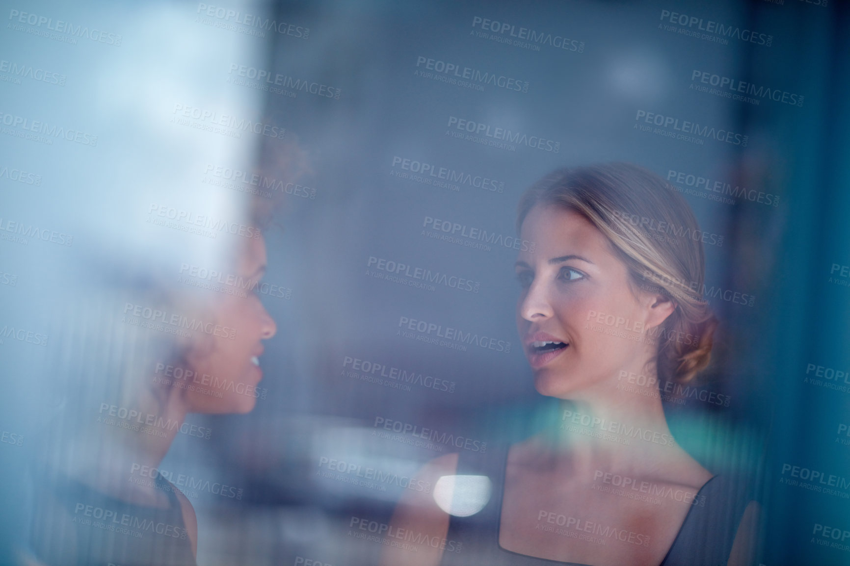 Buy stock photo Cropped shot of two businesswomen having a discussion in an office