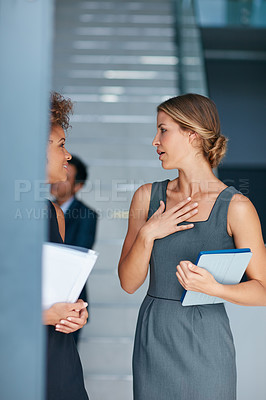 Buy stock photo Cropped shot of two businesswomen having a discussion in an office