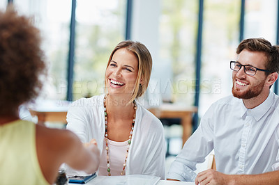 Buy stock photo Shot of a group of businesspeople meeting a new colleague