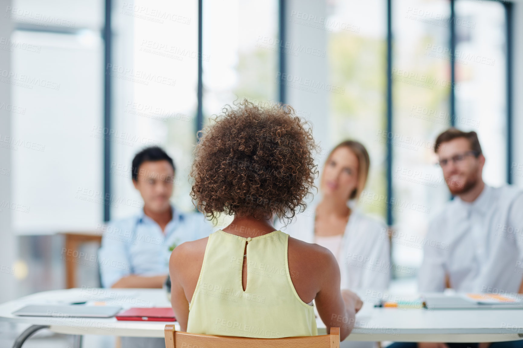 Buy stock photo Shot of a woman being interviewed by a team of businesspeople