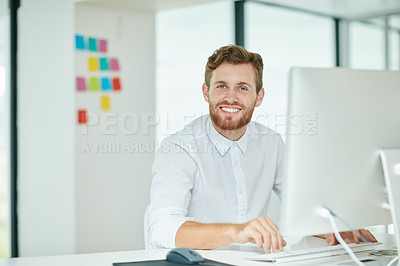 Buy stock photo Shot of a businessman working on his computer in the office