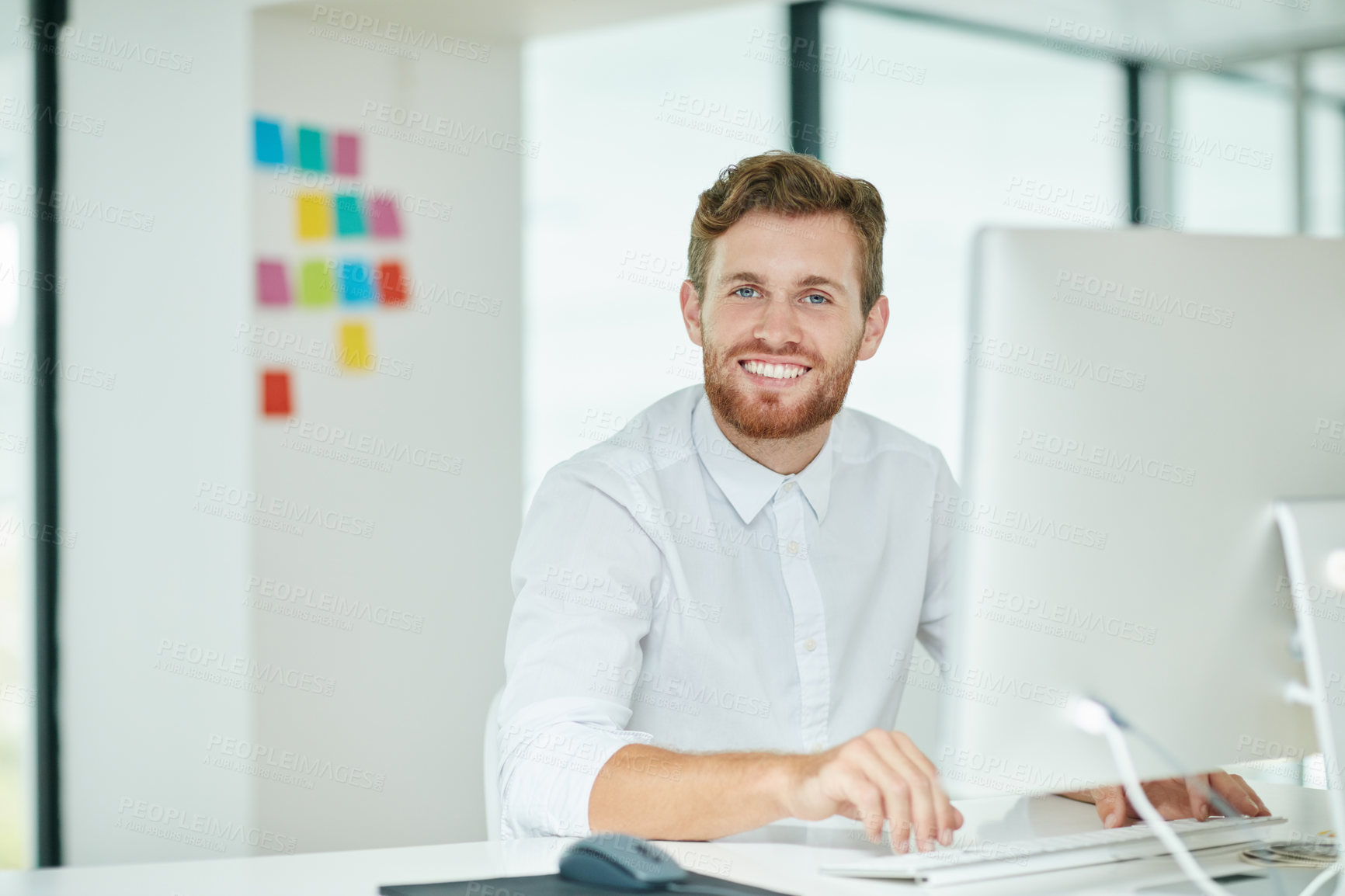 Buy stock photo Shot of a businessman working on his computer in the office