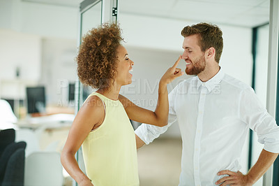 Buy stock photo Shot of a businesswoman touching her colleagues nose  playfully in the office