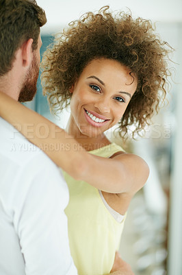 Buy stock photo Portrait of a happy young woman embracing her boyfriend at home