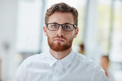 Buy stock photo Portrait of a serious young businessman in the office