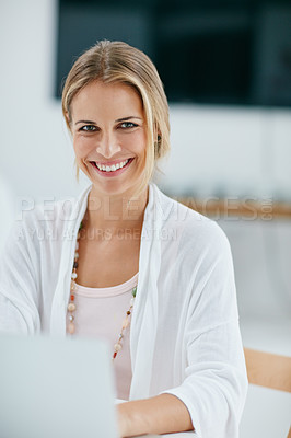 Buy stock photo Portrait of a happy businesswoman working on her laptop in her office