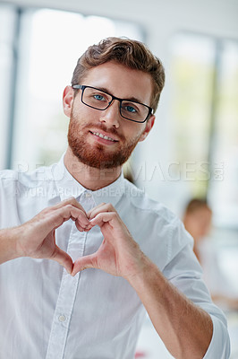 Buy stock photo Portrait of a businessman making a heart shape with his hands over his chest