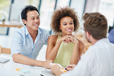 Buy stock photo Shot of a young couple meeting with their advisor in his office