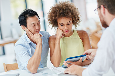 Buy stock photo Shot of a young couple meeting with their advisor in his office