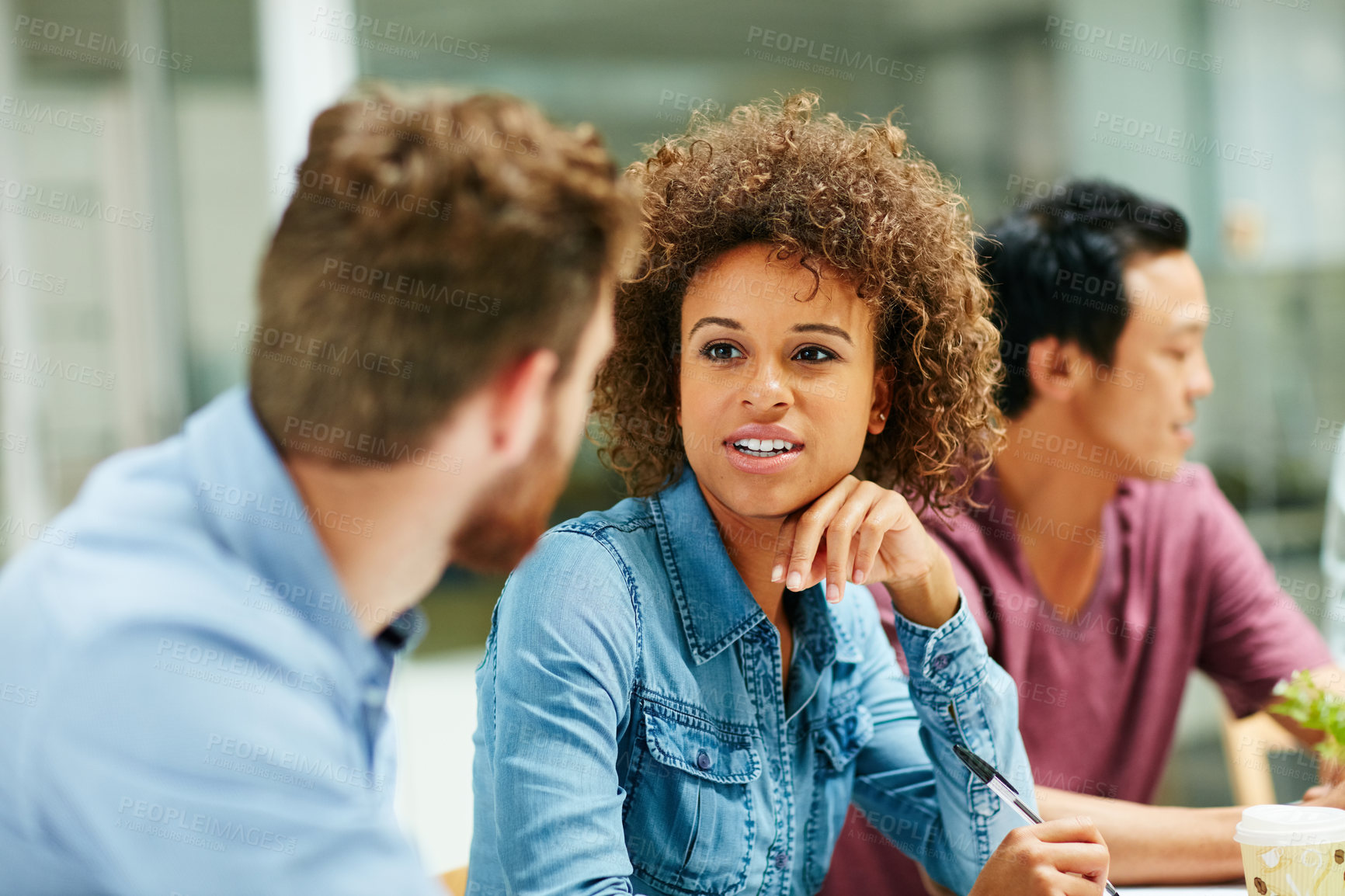 Buy stock photo Shot of a group of smiling businesspeople talking together around a table in an office