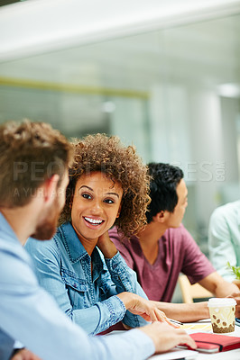 Buy stock photo Shot of a group of smiling businesspeople talking together around a table in an office