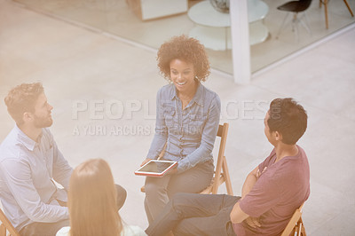 Buy stock photo High angle shot of a group of businesspeople talking together while sitting in a circle in an office
