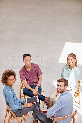 Buy stock photo High angle portrait of a group of businesspeople sitting together in a circle in an office