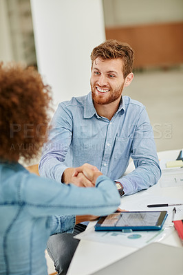 Buy stock photo Cropped shot of businesspeople shaking hands during a meeting
