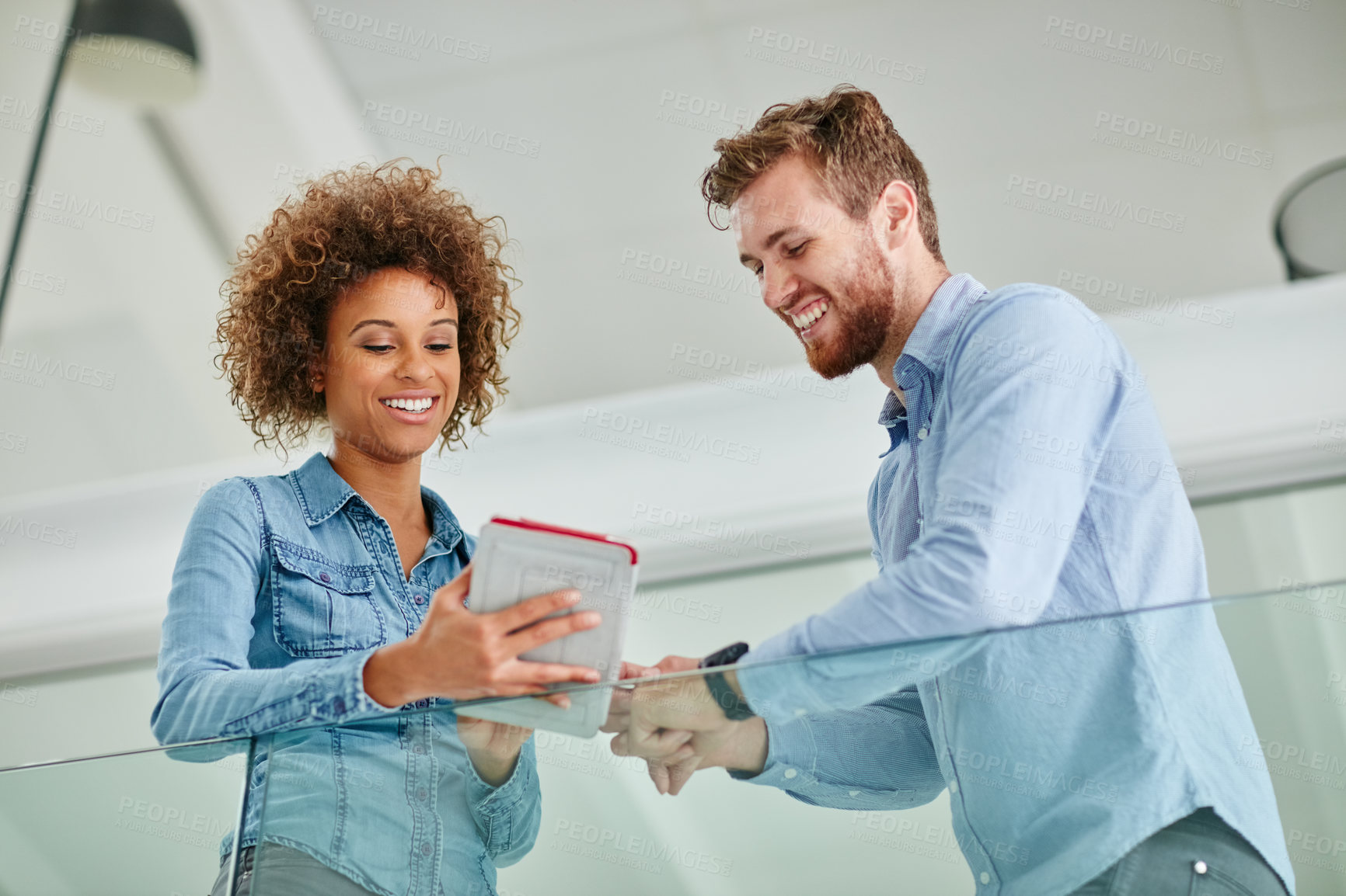 Buy stock photo Cropped shot of two colleagues having a discussion in an office