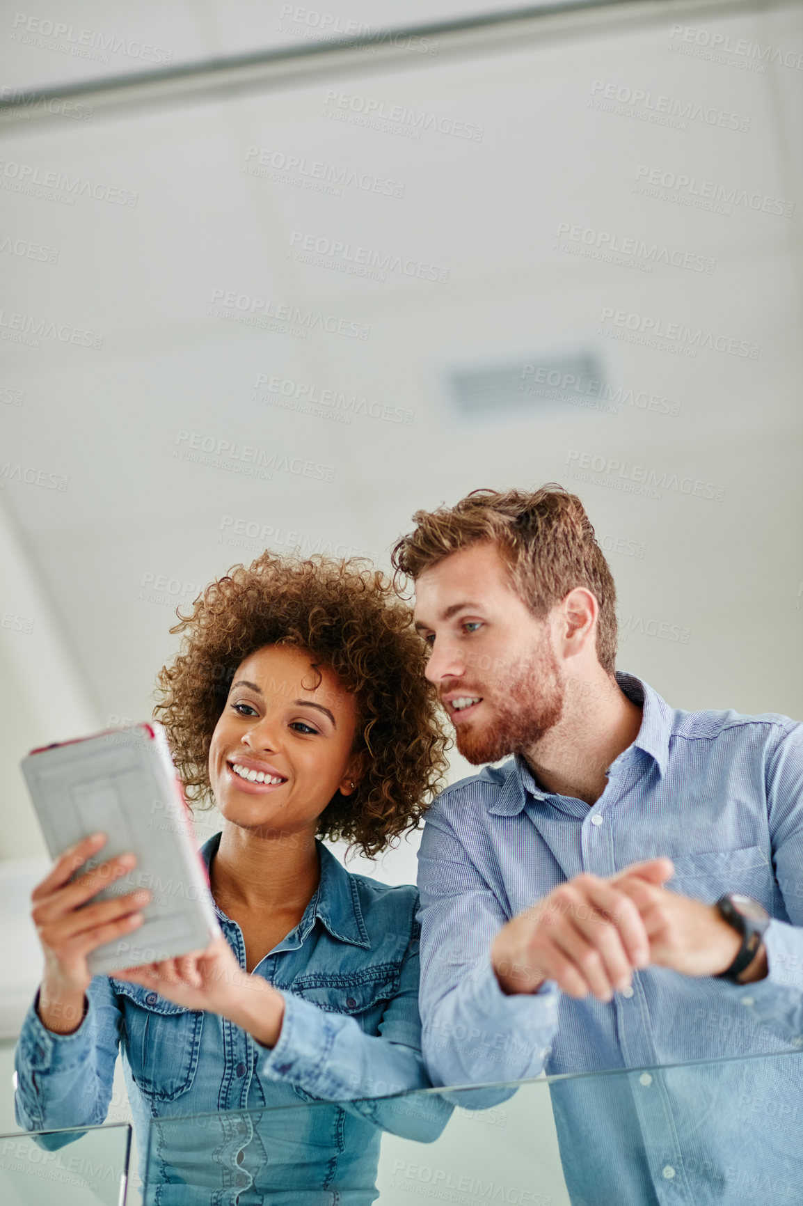 Buy stock photo Cropped shot of two colleagues having a discussion in an office