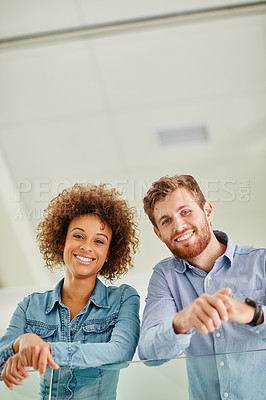 Buy stock photo Portrait of two colleagues standing together in an office