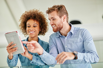 Buy stock photo Cropped shot of two colleagues having a discussion in an office