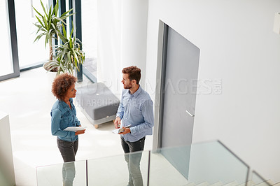 Buy stock photo Cropped shot of two colleagues  having a discussion in an office