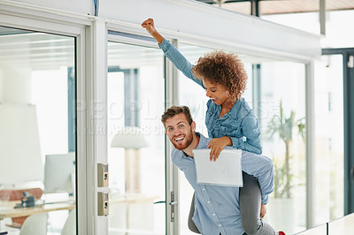 Buy stock photo Cropped shot of a young businessman piggybacking a colleague in an office