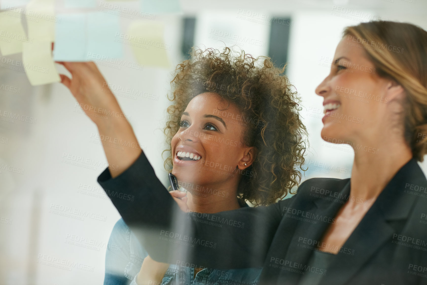 Buy stock photo Glass wall, sticky note and business people with brainstorming, women and smile in meeting. Modern office, employees and staff with planning, schedule and support for review, ideas and teamwork