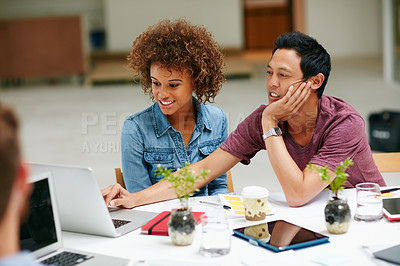 Buy stock photo Shot of a group of businesspeople working together at a table in an office