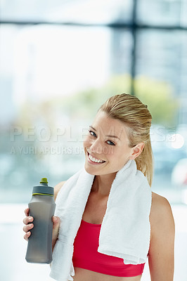 Buy stock photo Cropped portrait of an attractive young woman drinking water after a workout