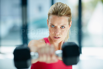 Buy stock photo Cropped portrait of an attractive young woman working out with dumbbells