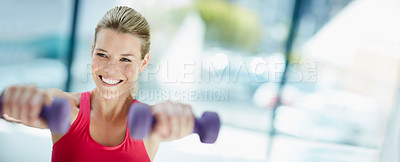 Buy stock photo Cropped shot of an attractive young woman working out with dumbbells