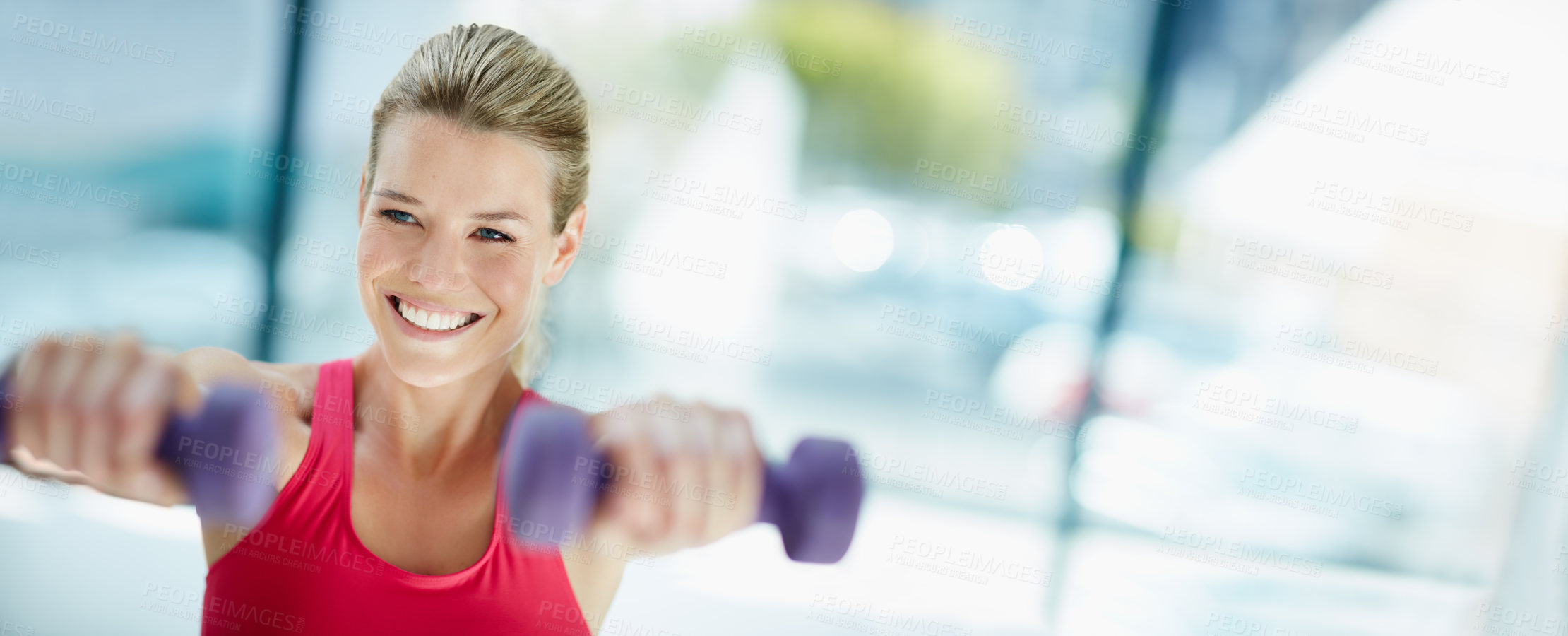 Buy stock photo Cropped shot of an attractive young woman working out with dumbbells