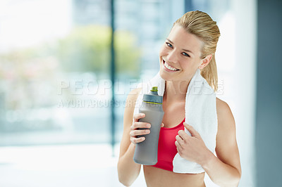 Buy stock photo Cropped portrait of an attractive young woman drinking water after a workout