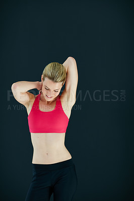 Buy stock photo Cropped shot of an attractive young woman warming up before a workout