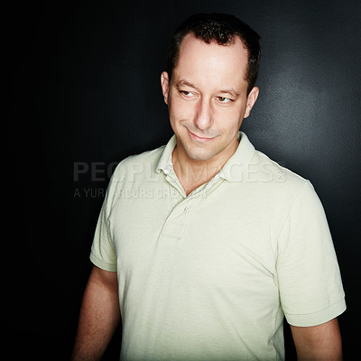 Buy stock photo Studio shot of a mature man standing against a dark background