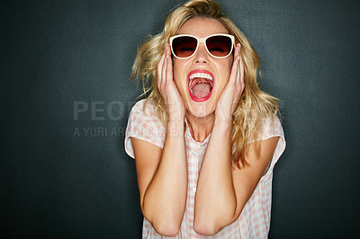 Buy stock photo Cropped shot of a young woman wearing sunglasses against a grey background