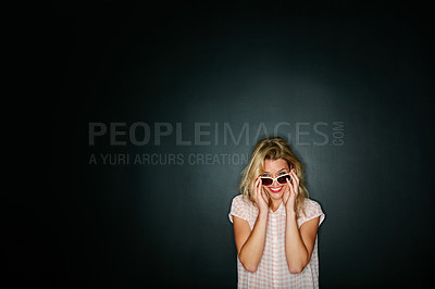 Buy stock photo Cropped shot of a young woman wearing sunglasses against a grey background