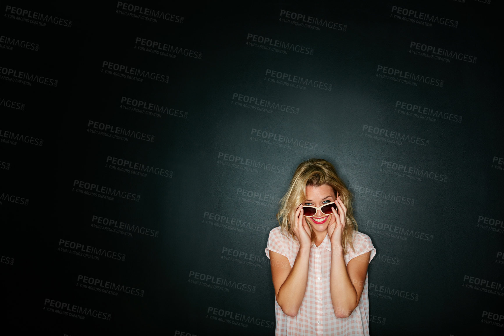 Buy stock photo Cropped shot of a young woman wearing sunglasses against a grey background